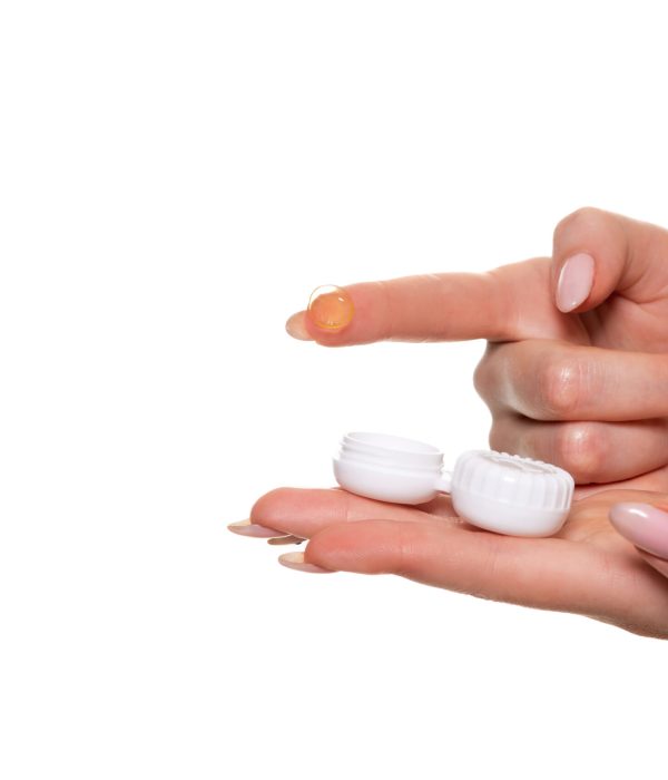 Contact eye lens. Close-up of woman hands holding white eyelense container. Woman fingers holding eye lense box. Health and eyes care concep